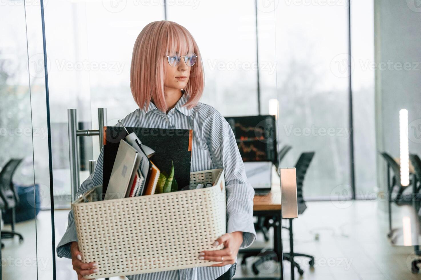 With personal belongings ,in ,the box. Unemployed woman is after being fired photo