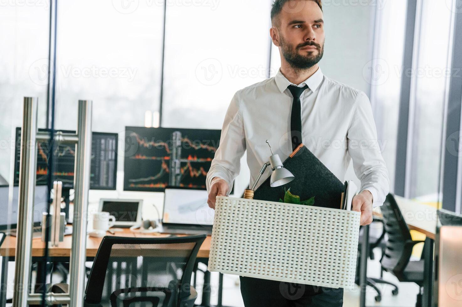 Sad person. Unemployed man is with personal belongings after being fired photo