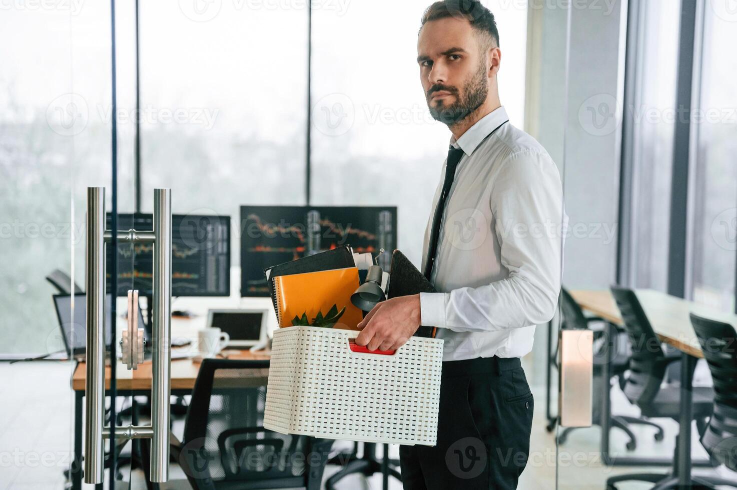 Sad person. Unemployed ,man ,is, with personal belongings after being fired photo