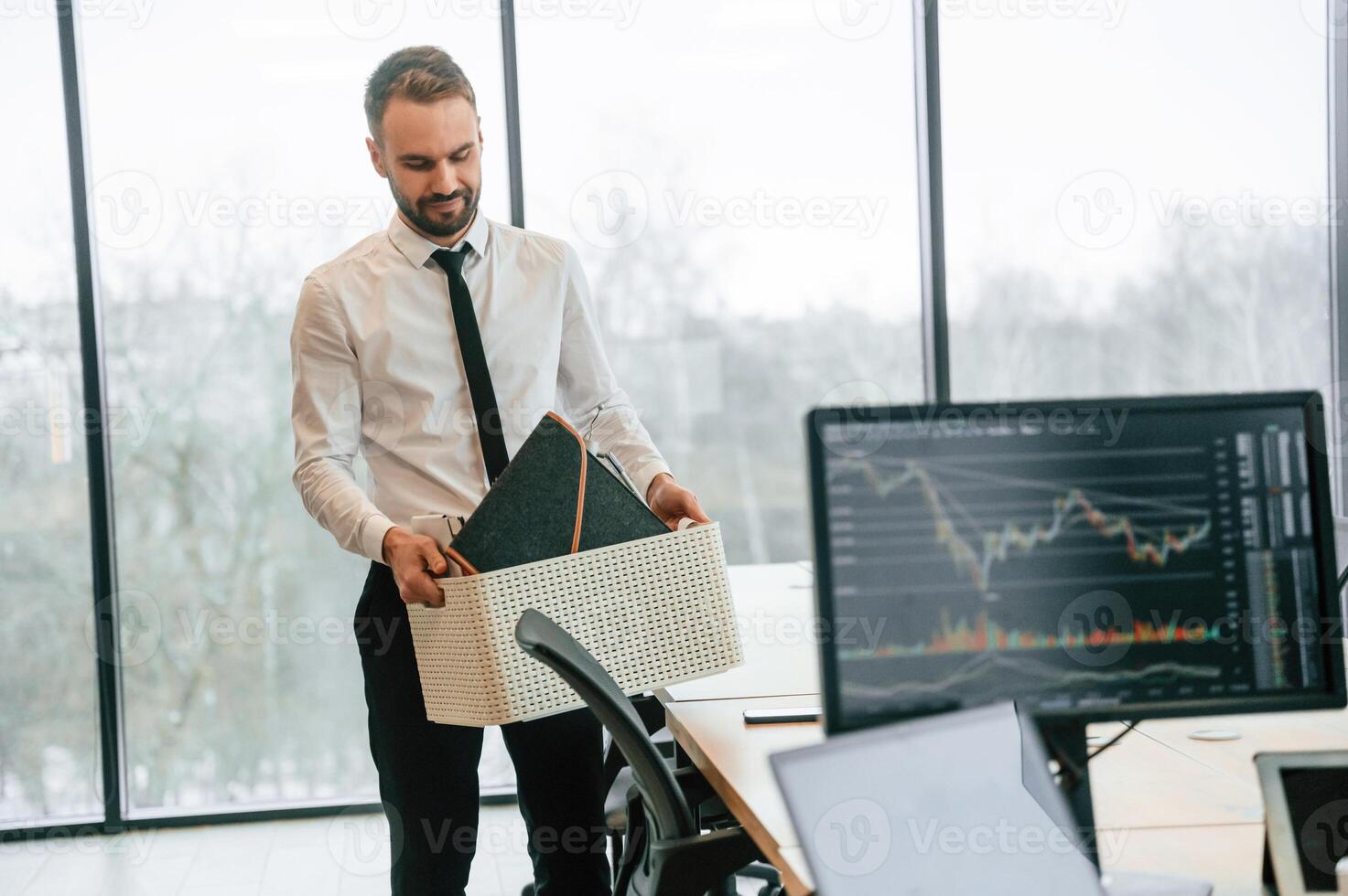 Sad, person. Unemployed man is with personal belongings after being fired photo