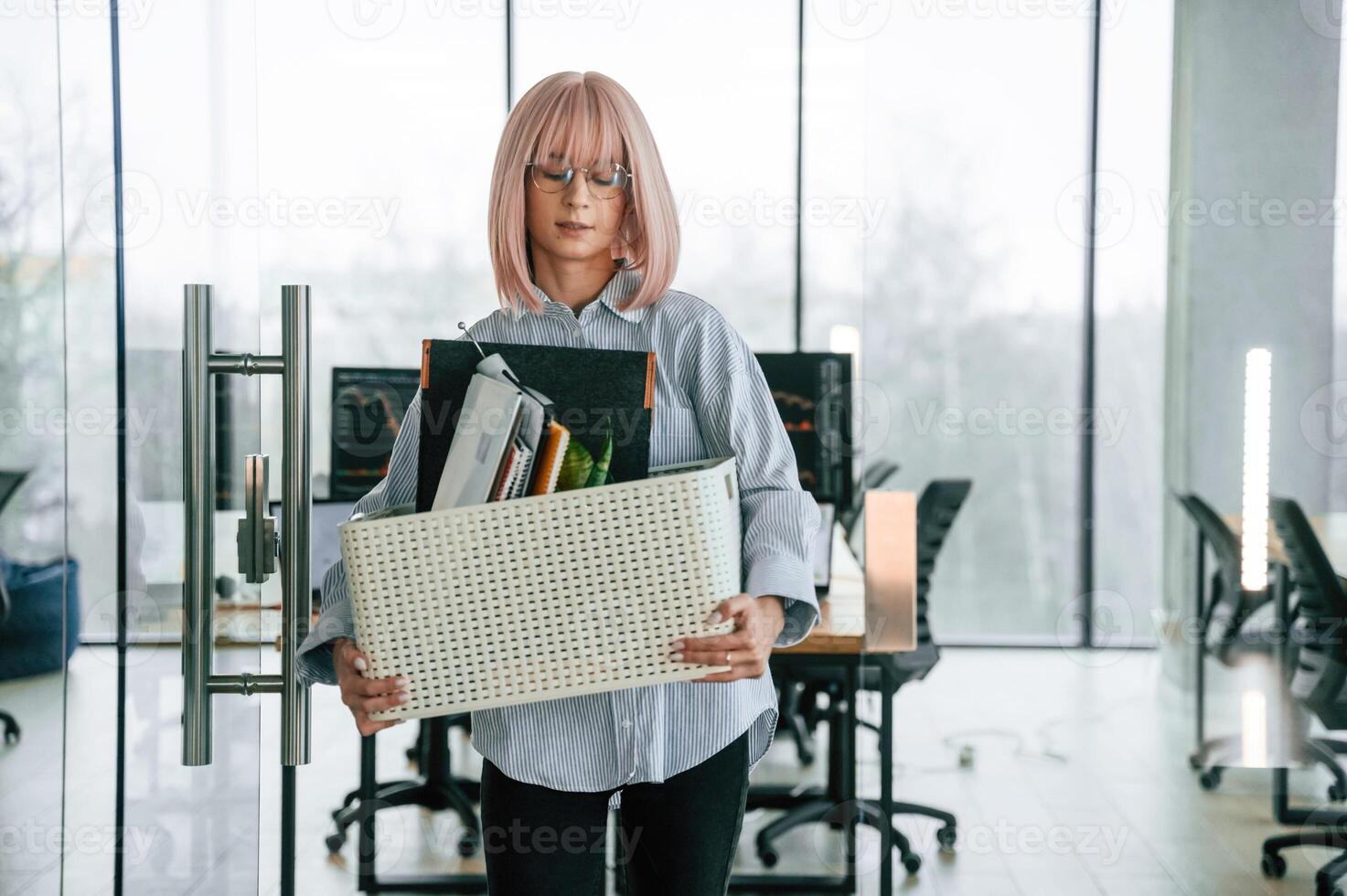 With ,personal belongings in the box. Unemployed woman is after being fired photo