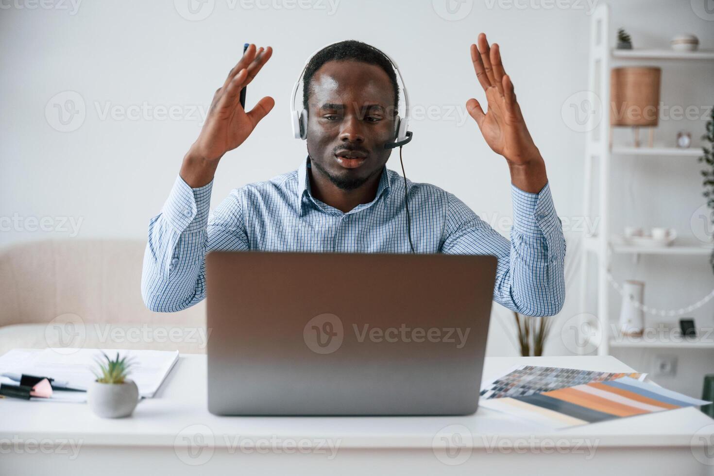 Failure, with hands up, shocked. Businessman is working in the office by laptop photo
