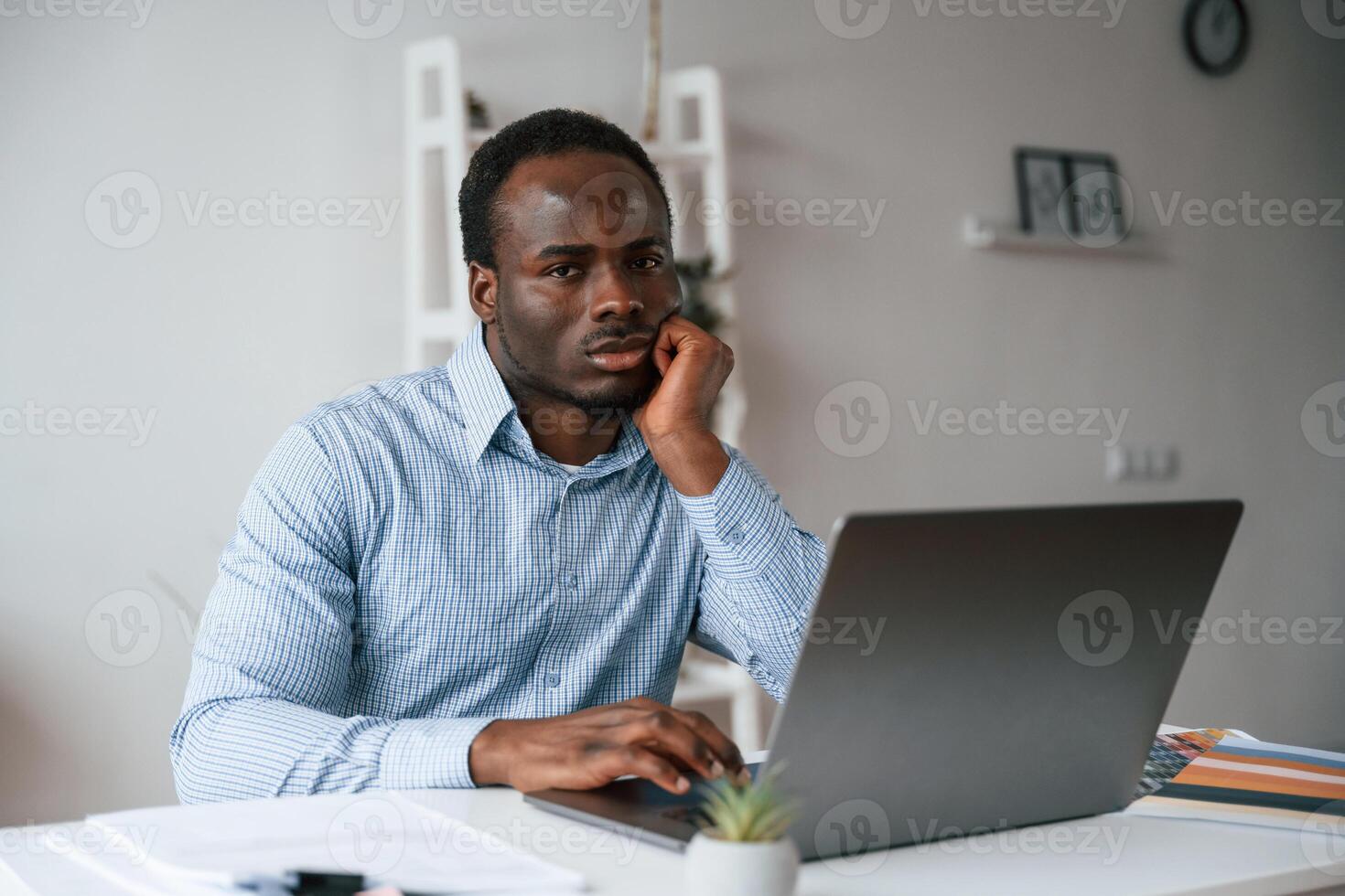 Front,, view. Businessman is working in the office by laptop photo