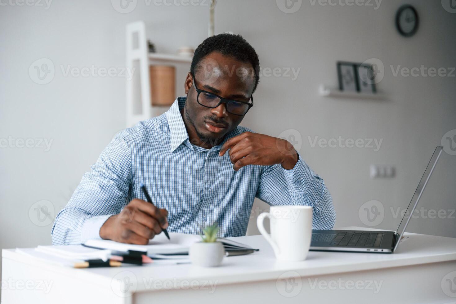 Manager, is, using laptop. ..Businessman is working in the office photo