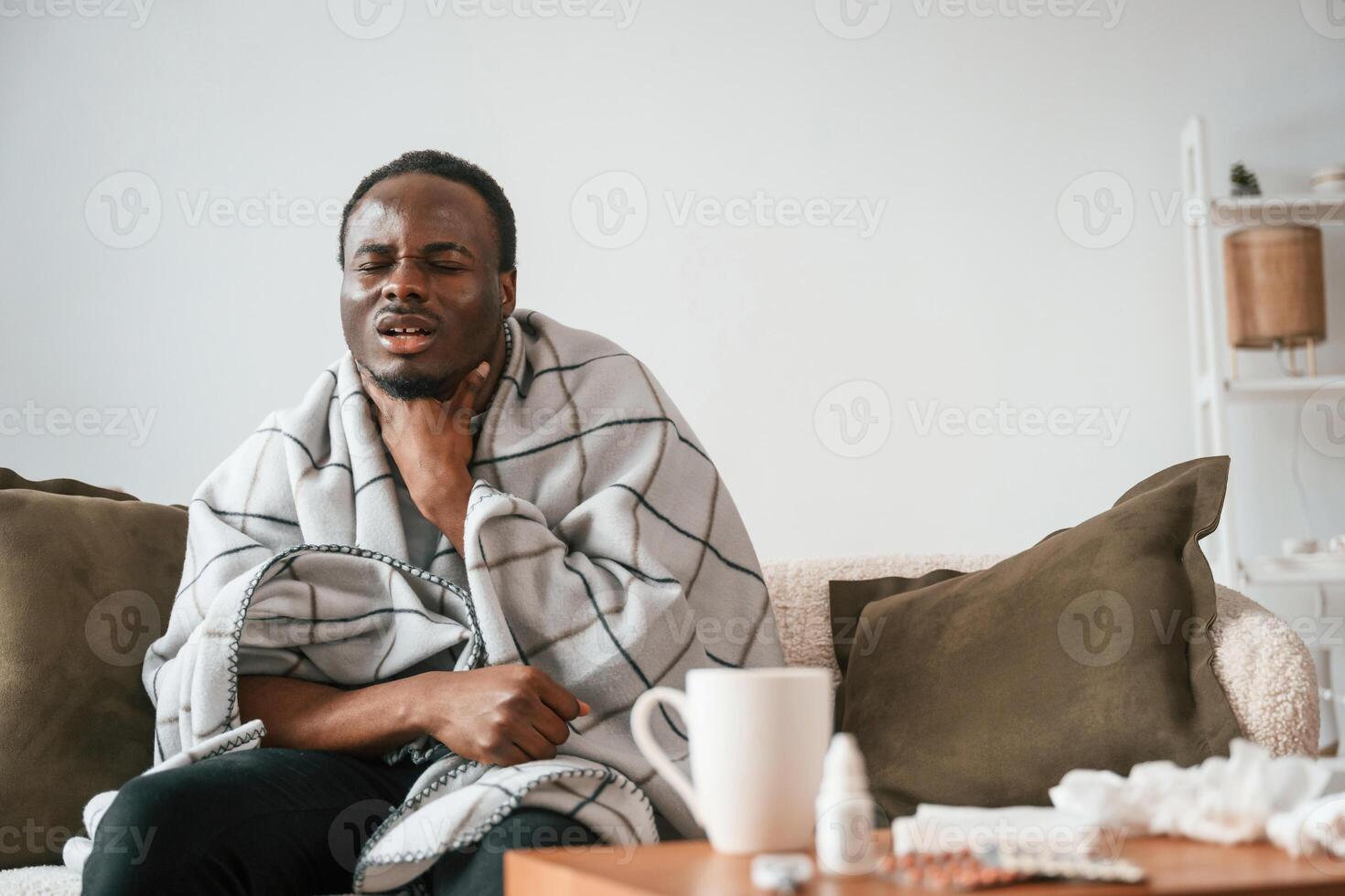 Pain in, the throat. Sick black man is at home photo
