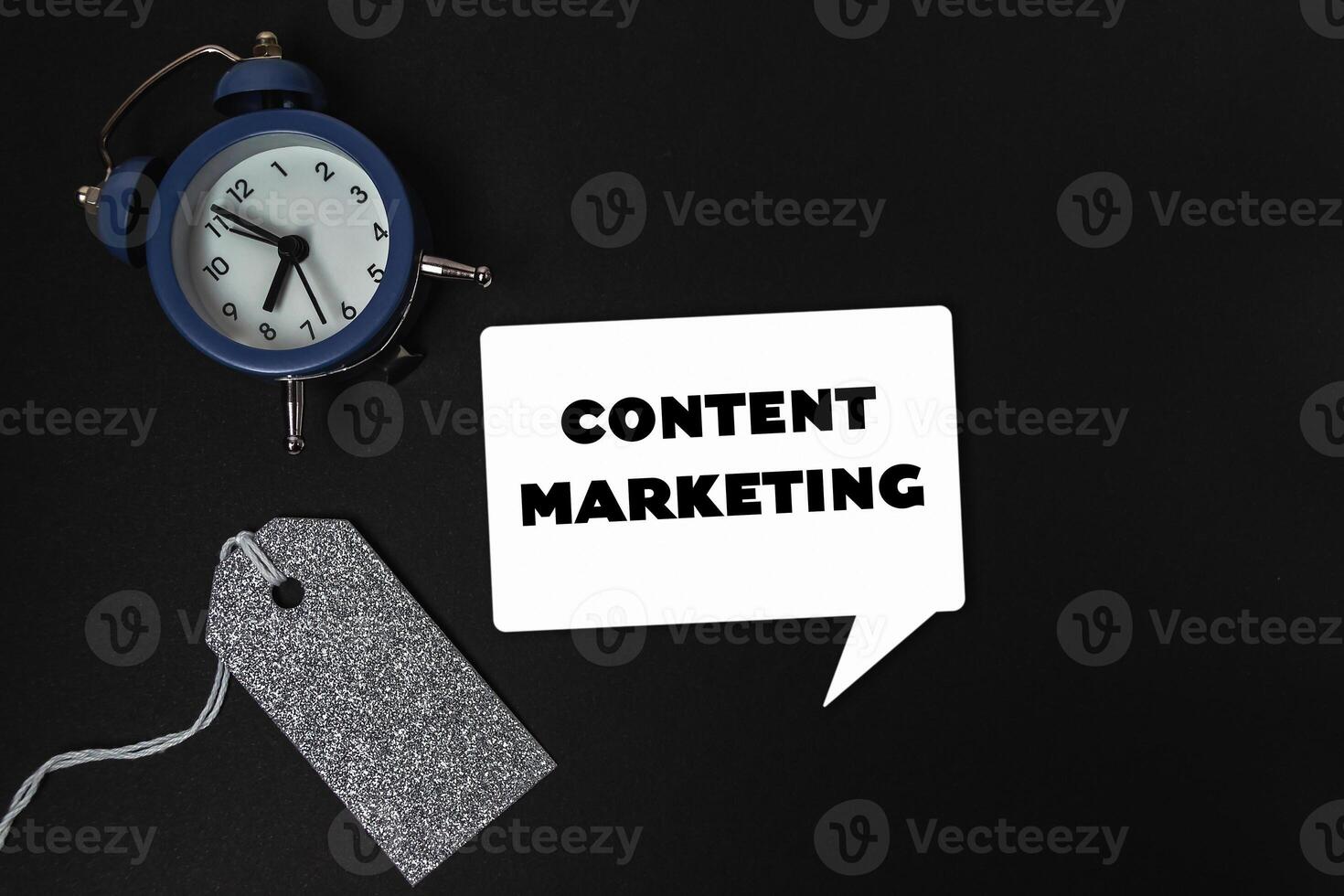 The clock is positioned in the center of the image, with the tag hanging from it photo