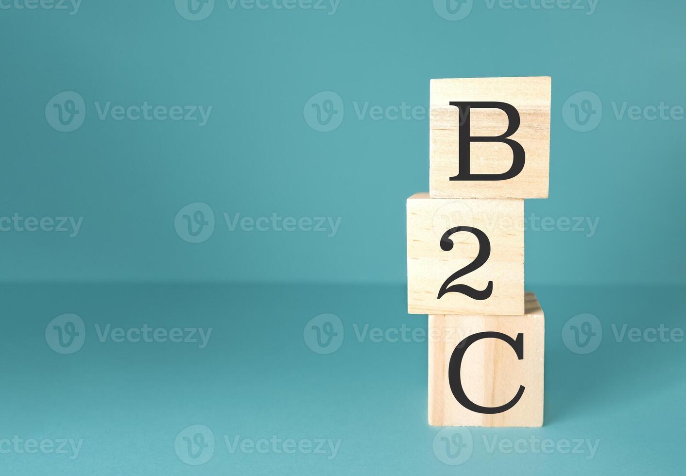 Three wooden blocks stacked on top of each other with the letters B, C photo