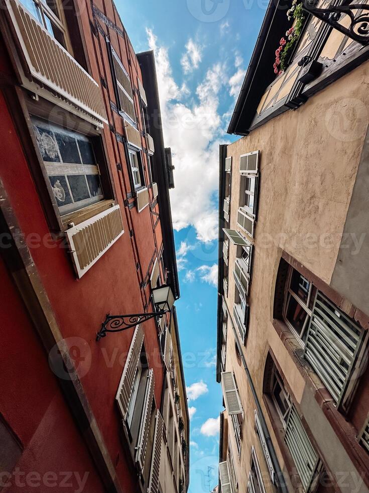 Two buildings with windows and a blue sky in the background photo