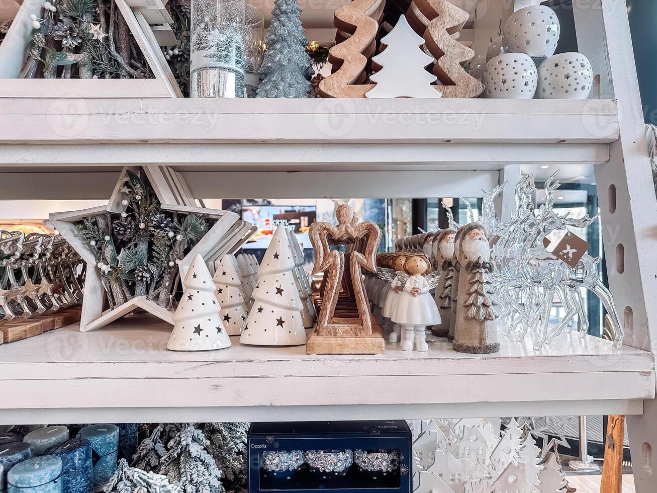 Shelf full of Christmas decorations including angels, stars, and trees photo