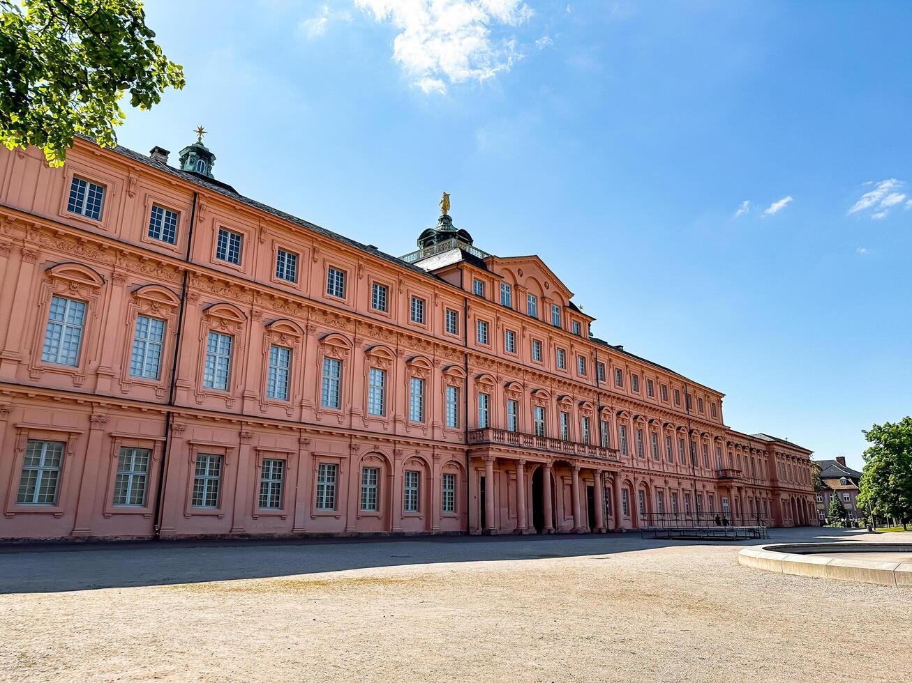 Rastatt, Germany - May 9, 2024 - Large pink building with a green dome on top photo