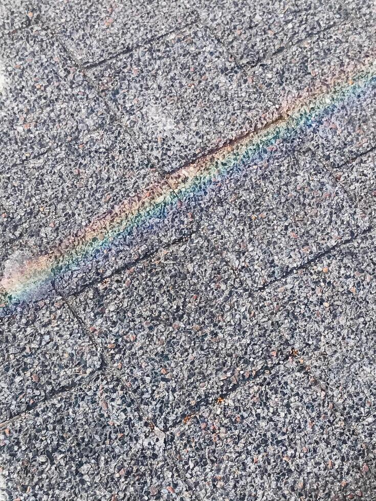 A rainbow is reflected on a gray roof photo