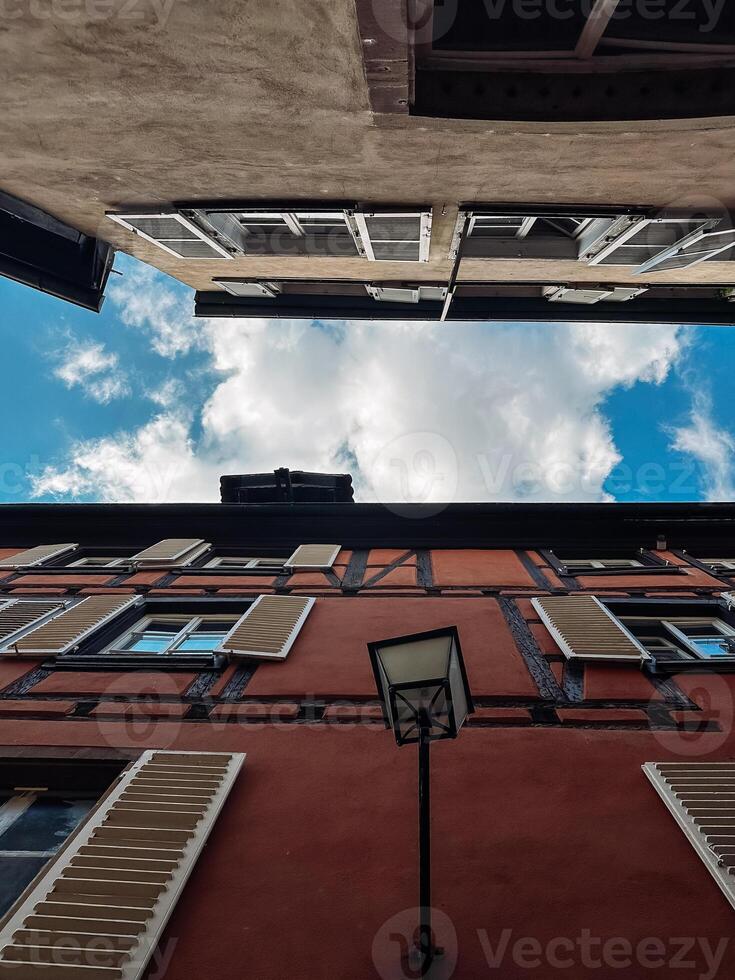 Street view of a city with a cloudy sky and a lamp post photo