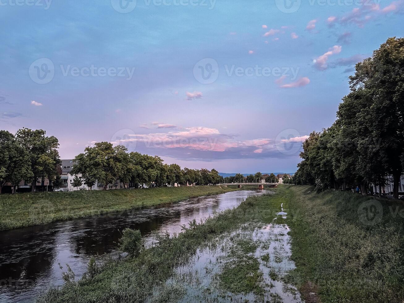 River is flooded with water and trees are in the background photo