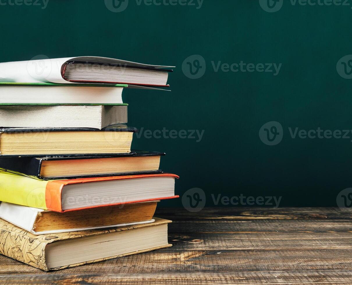 stack of books on wooden table photo