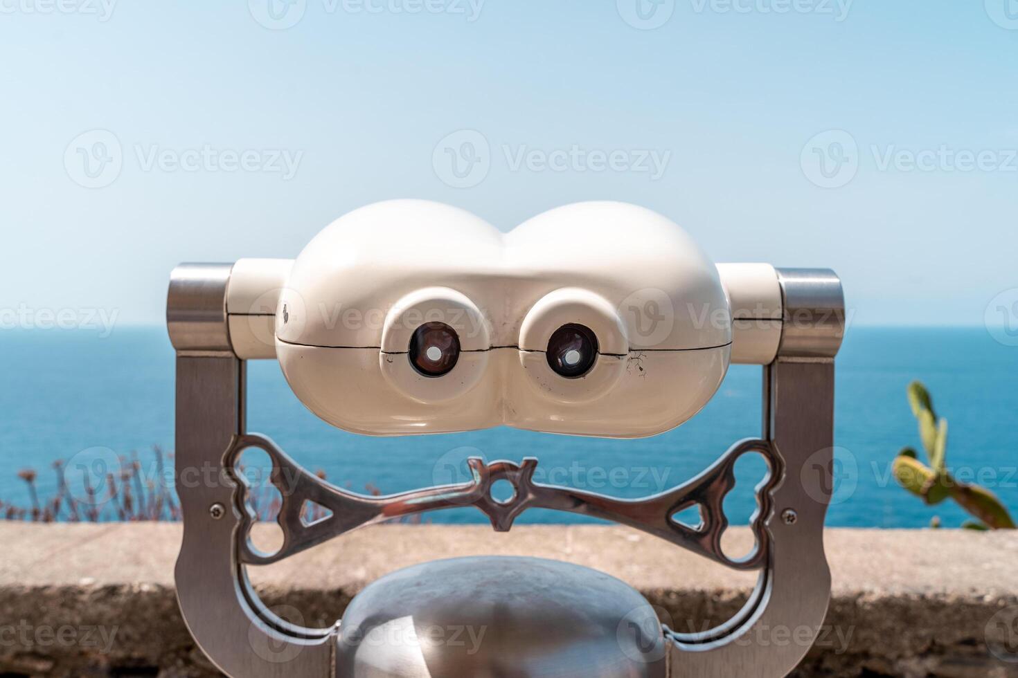 Tourist binocular telescope on a terrace on the sea photo