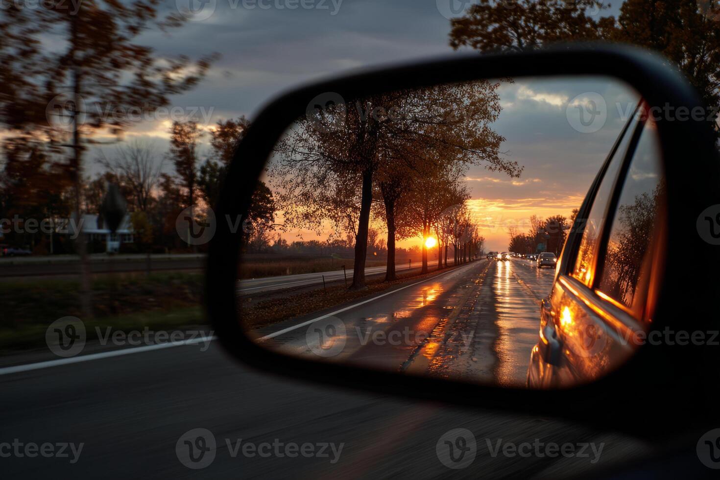 Sunset road view in car rear view mirror reflection photo