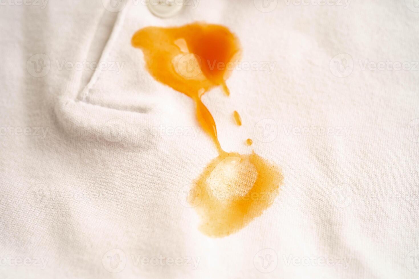 Dirty tomato sauce stain removal or ketchup on cloth accident to wash with washing powder photo
