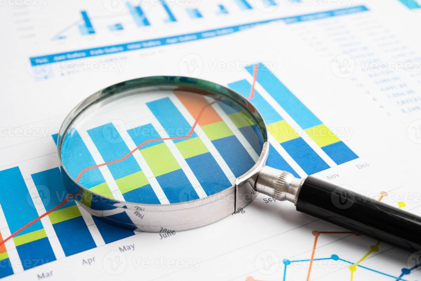 Magnifying glass on charts photo