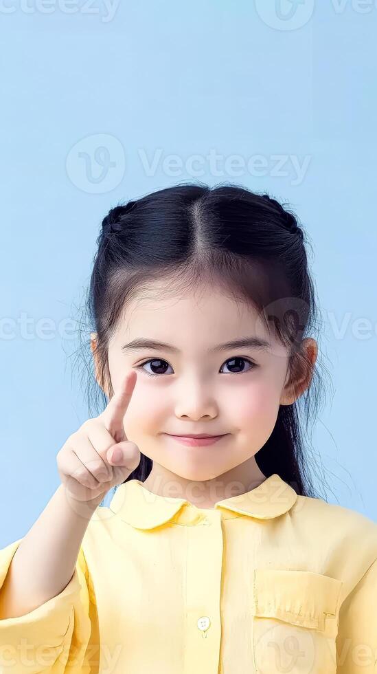Young girl is smiling and pointing to the sky photo