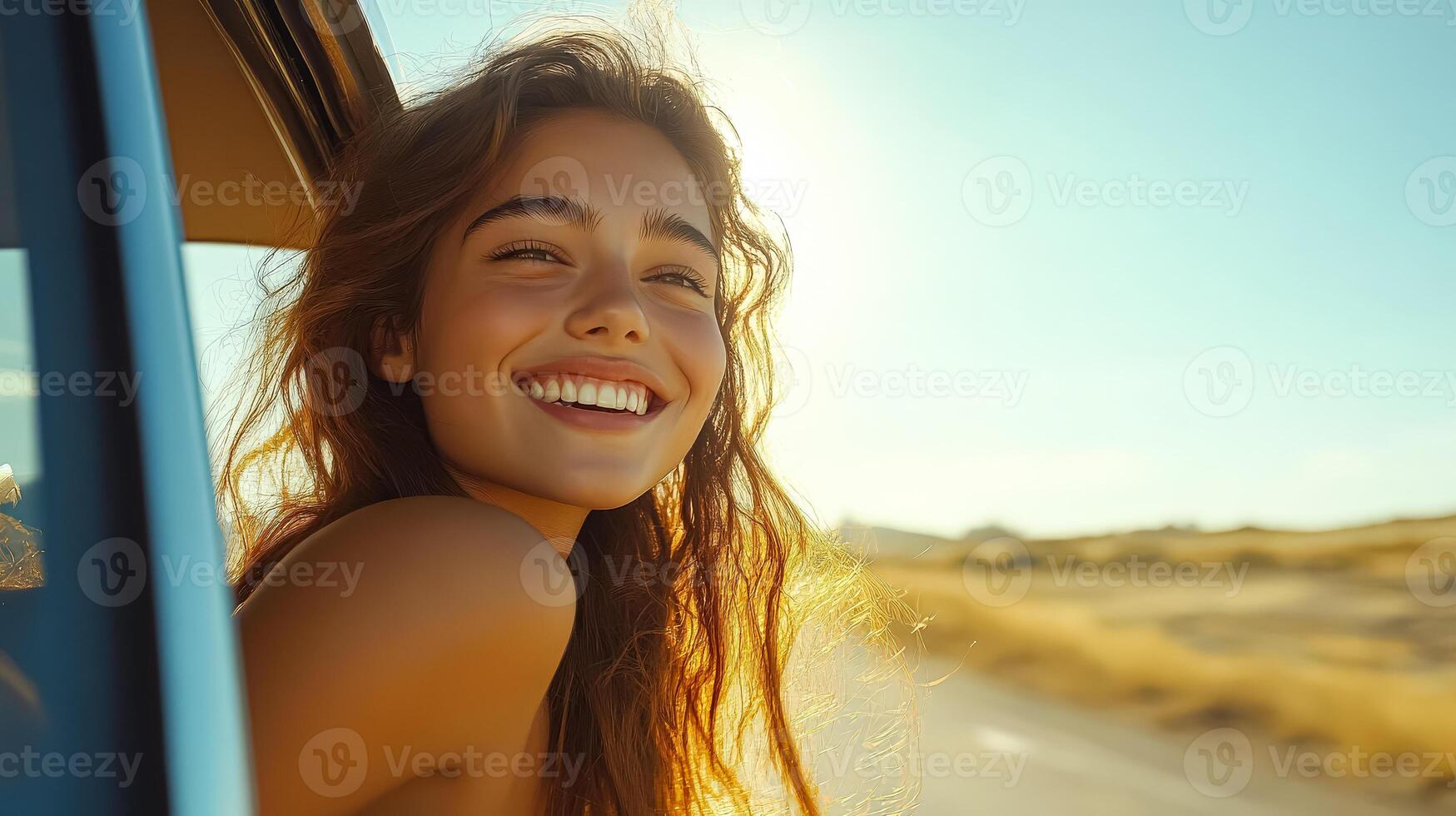 Woman with long hair is smiling and looking out the window of a car photo