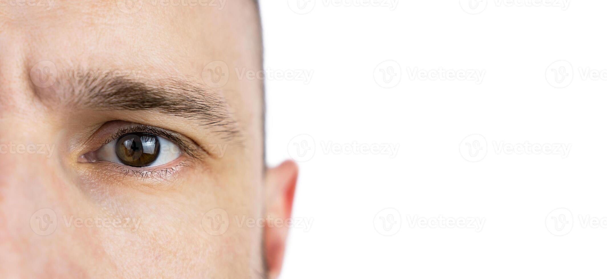 Banner. The eye of a young man on a white background. Close-up. Place for text. Selective focus. photo