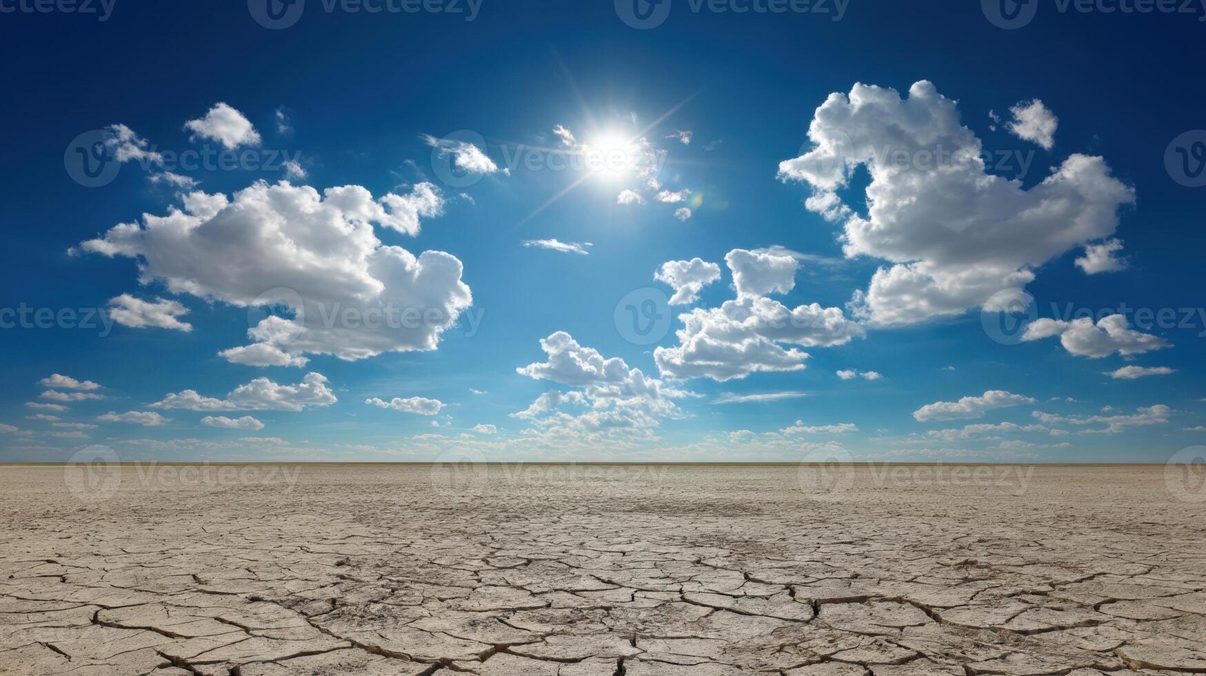 Bright Sunny Day over Arid Desert Landscape with Cracked Earth photo