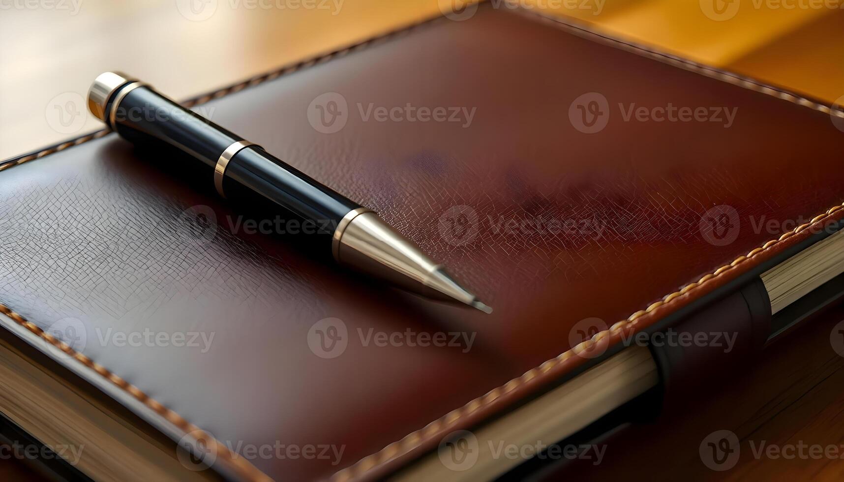 a notebook with a pen on top of it photo