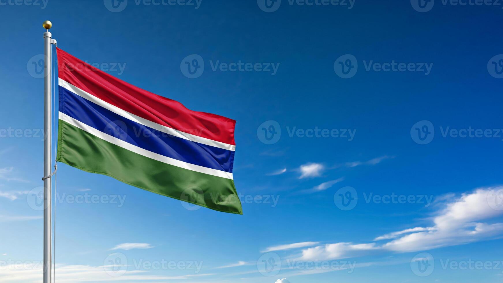 national flag of gambia waving on the wind, banner in the blue sky photo