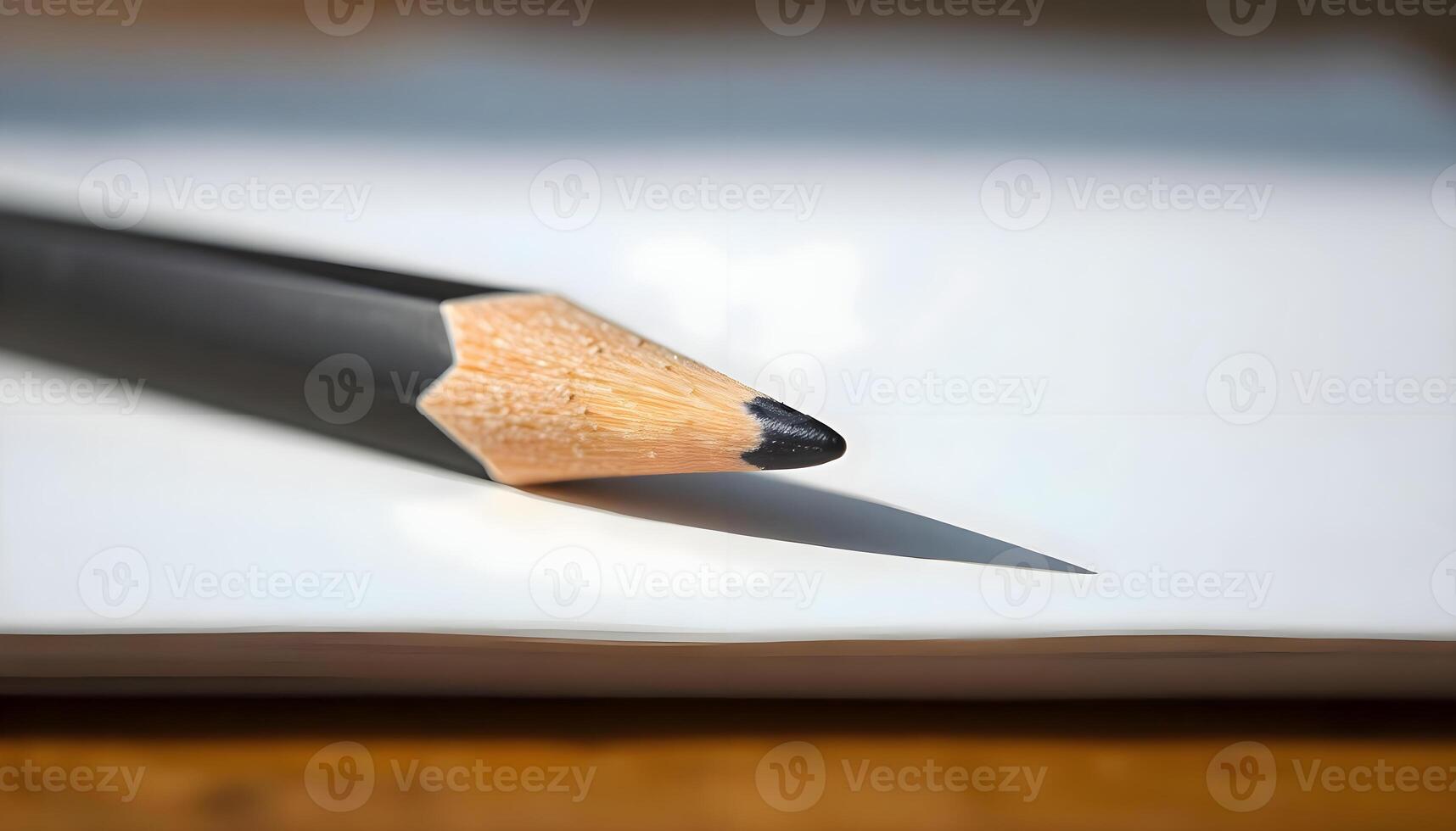 A pencil is sitting on top of a piece of paper photo