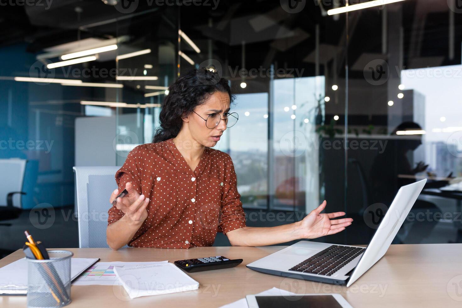 Businesswoman disappointed and sad at work, not happy with the result of achievement at work, Hispanic woman desperate and sad working inside office using laptop at work. photo