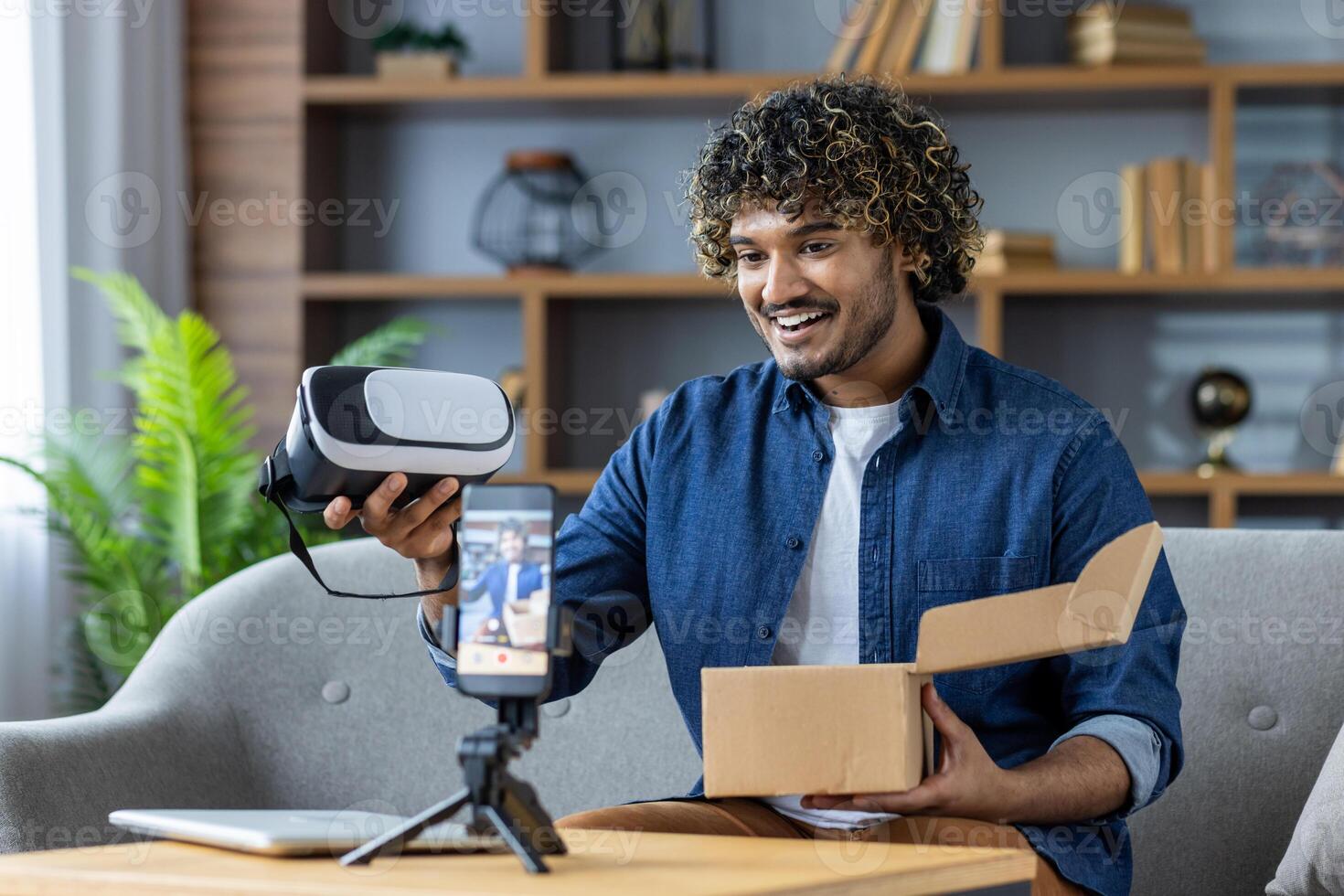 Man unboxing virtual reality headset during a livestream at home photo