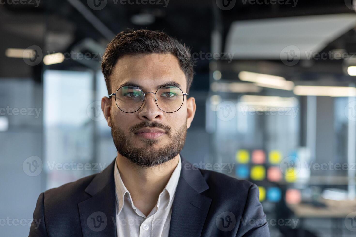 Close-up portrait of successful confident businessman, man in business suit looking at camera, financier investor at workplace inside office photo