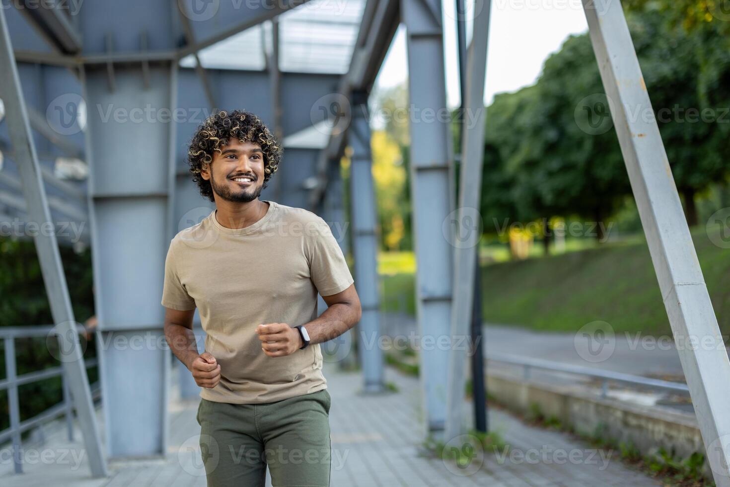 Young man running and doing active physical exercises, dressed in sporty casual clothes. photo