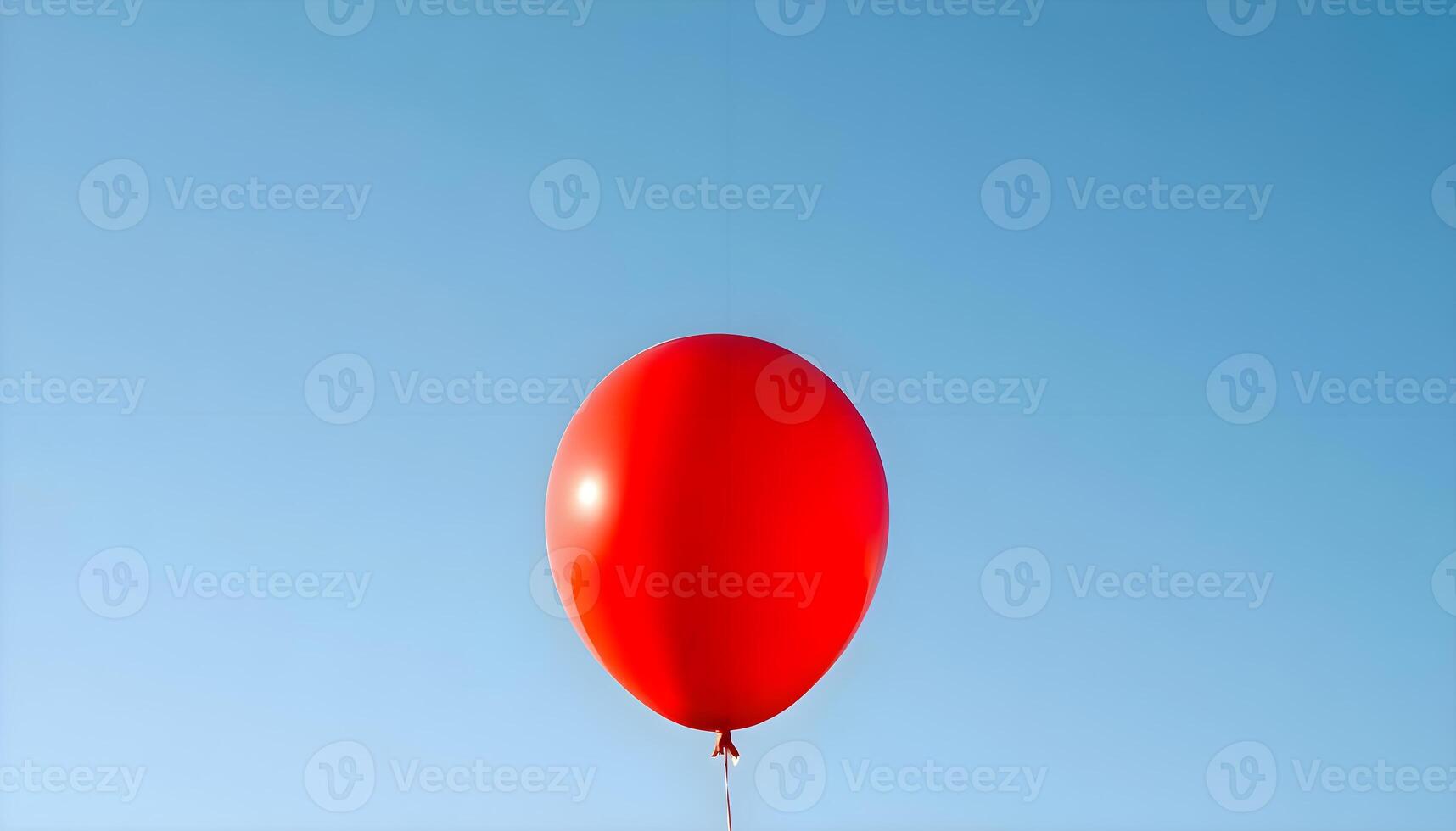 A red balloon is flying in the sky photo