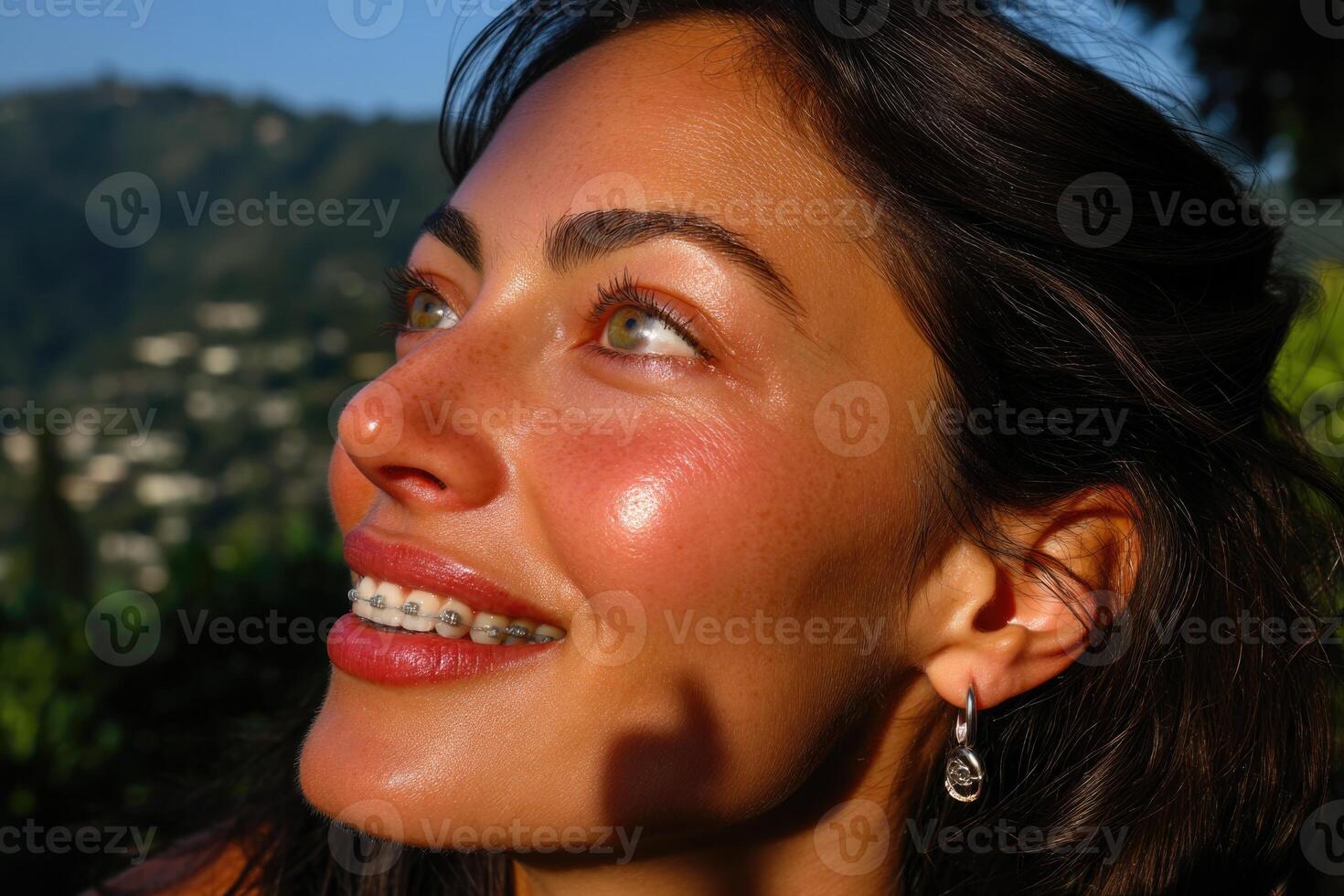 A woman with braces smiling at the camera photo