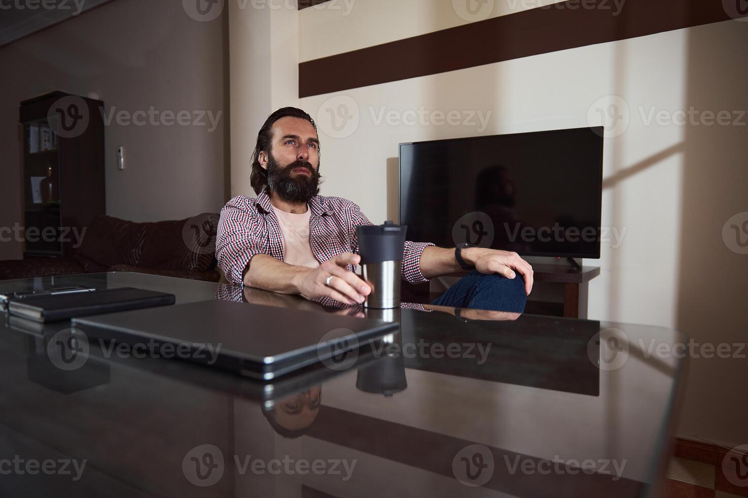 Young Professional Relaxing at Home Office With Work Materials photo