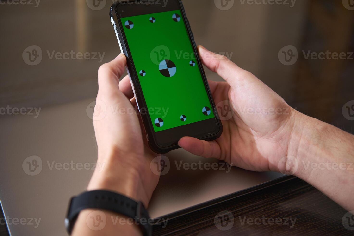 Hands Holding Smartphone With Green Screen for Digital Content Creation photo