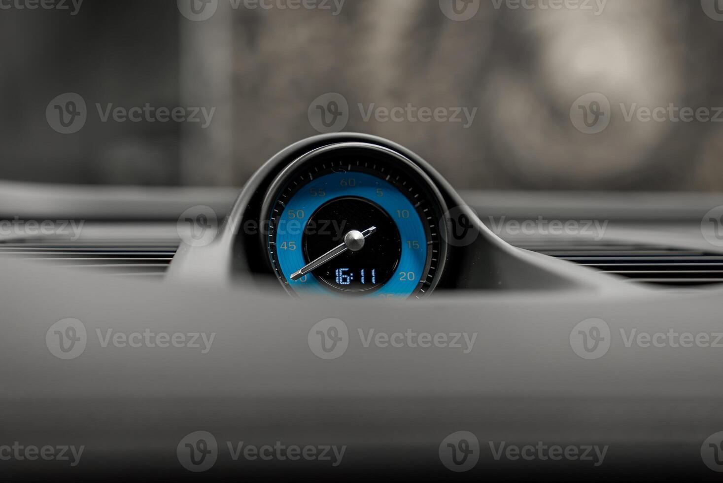 A close up of a car's dashboard with a blue gauge photo
