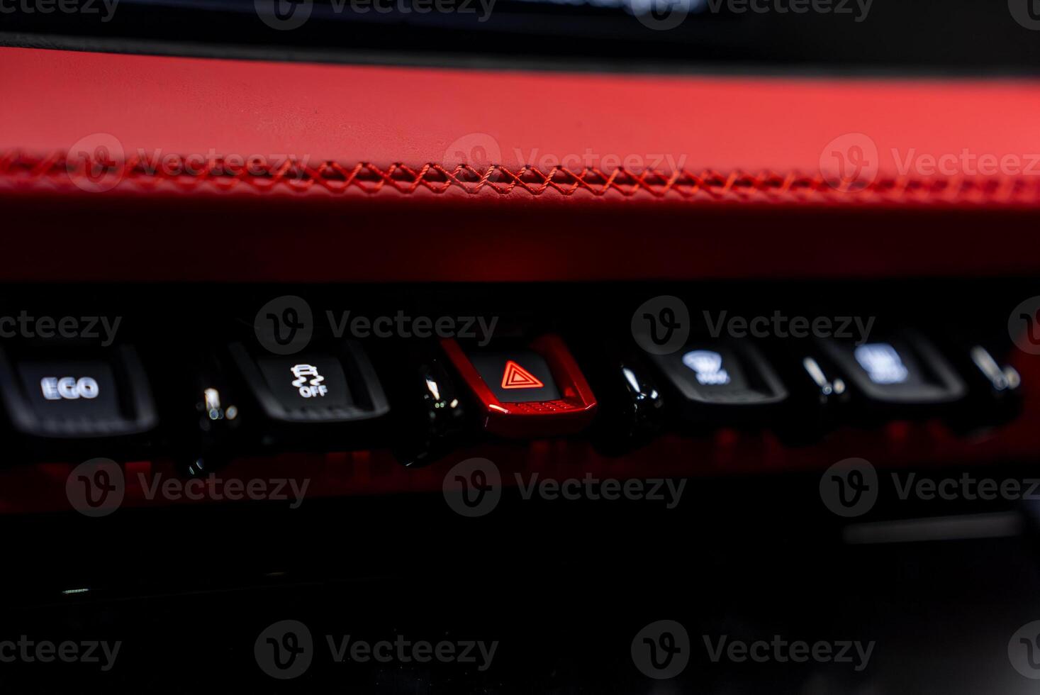 The red button on the center console of a car photo