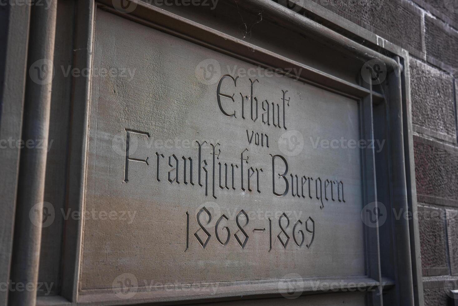 Weathered Metal Plaque on Stone Wall in Frankfurt, Germany photo