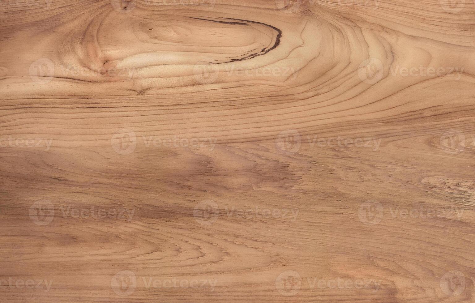 Natural wood surface with rich swirling grain and organic brown tones photo