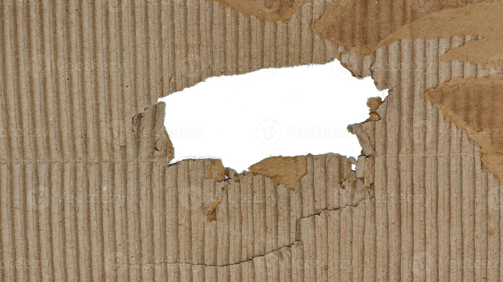 Small hole, Brown paper box texture or cardboard with torn for design background photo