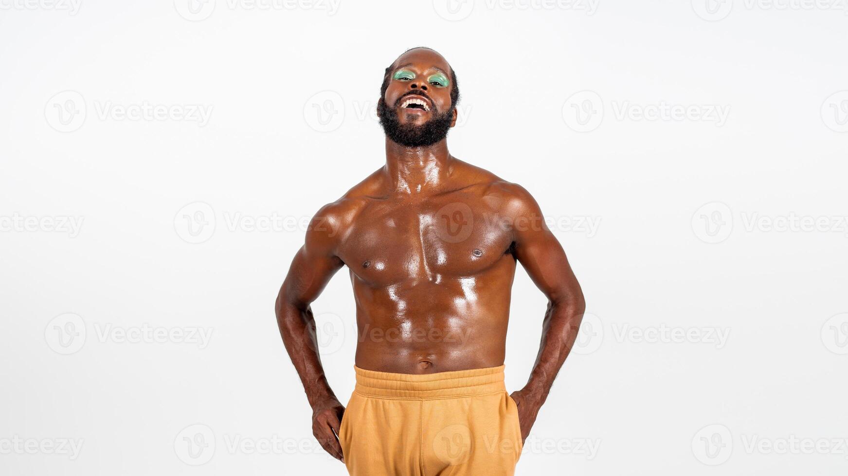 Laughing bearded gay man with bright makeup on white background photo