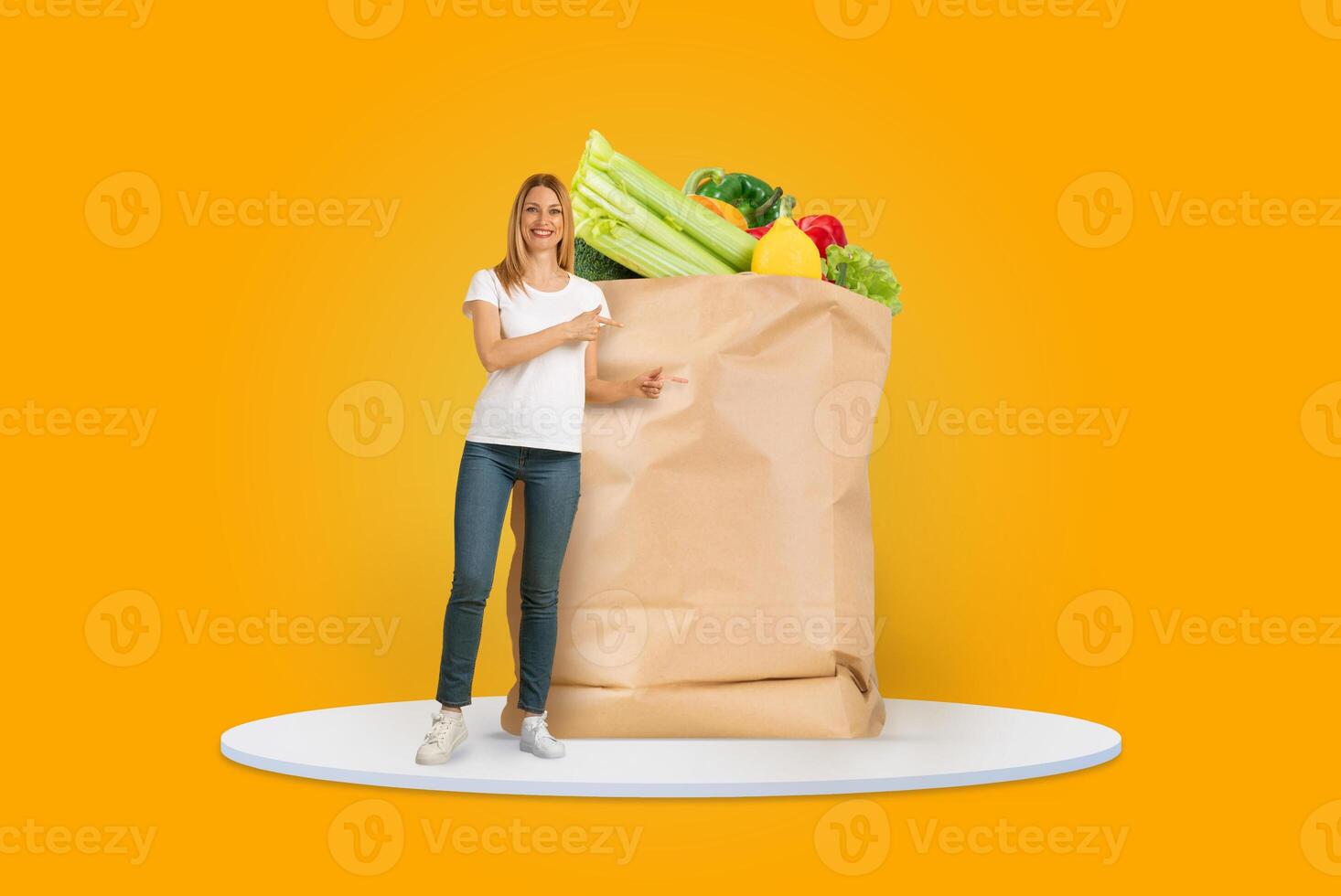 A customer stands next to a large paper bag brimming with fresh produce and groceries. The vibrant yellow background adds a cheerful touch to their shopping experience. photo