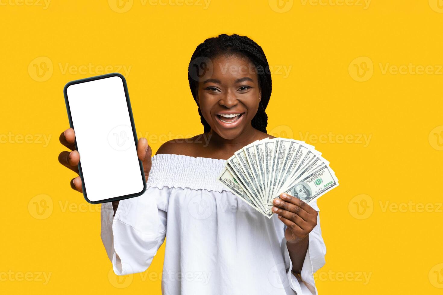 Money Prize. Joyful black lady celebrating success with dollar cash in hands, holding lot of banknotes and exclaiming with excitement, raising fist, cheering over yellow background with copy space photo