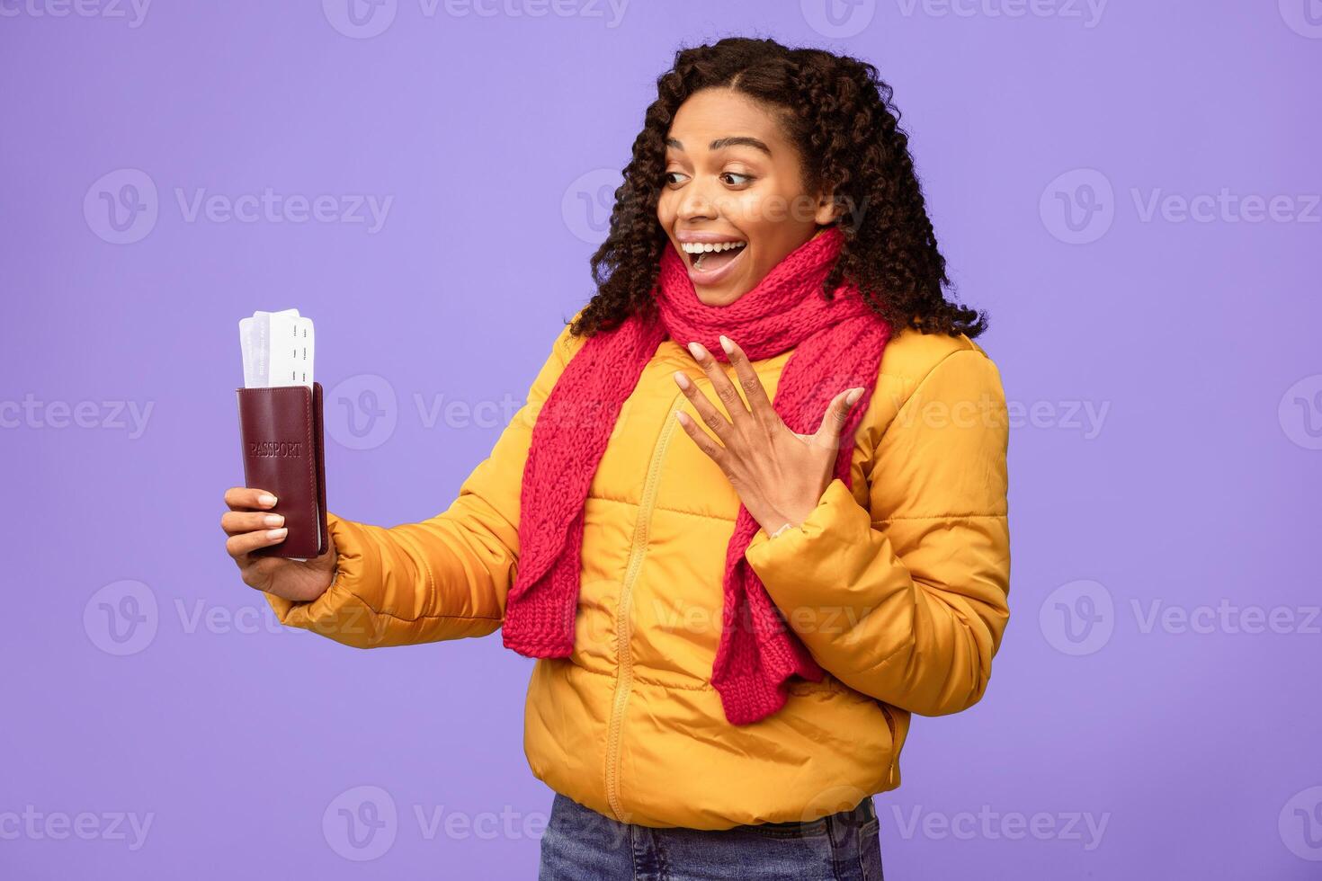 Excited Black Lady Traveller Holding Flight Tickets Travelling On Winter Vacation Standing Over Blue Background. Christmas Holidays Travel And Tourism Concept. Studio Shot photo