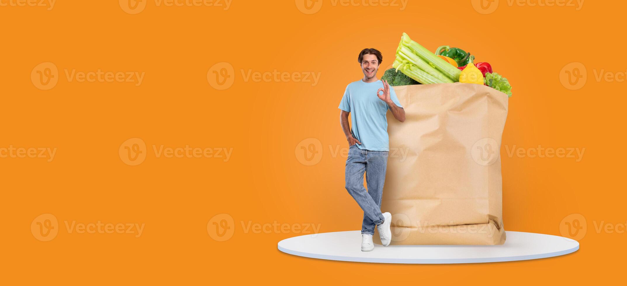 A customer stands by a large paper bag full of fresh groceries in a vibrant grocery store. This reflects the new shopping habits emerging in response to the pandemic. photo