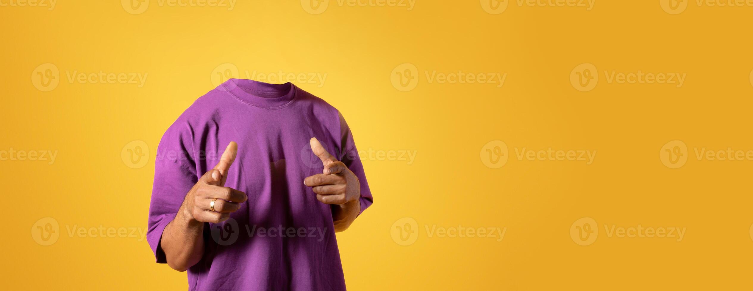 A person stands confidently in a stylish purple shirt against a bright yellow background, pointing with both hands. The headless depiction emphasizes a playful and artistic lifestyle approach. photo