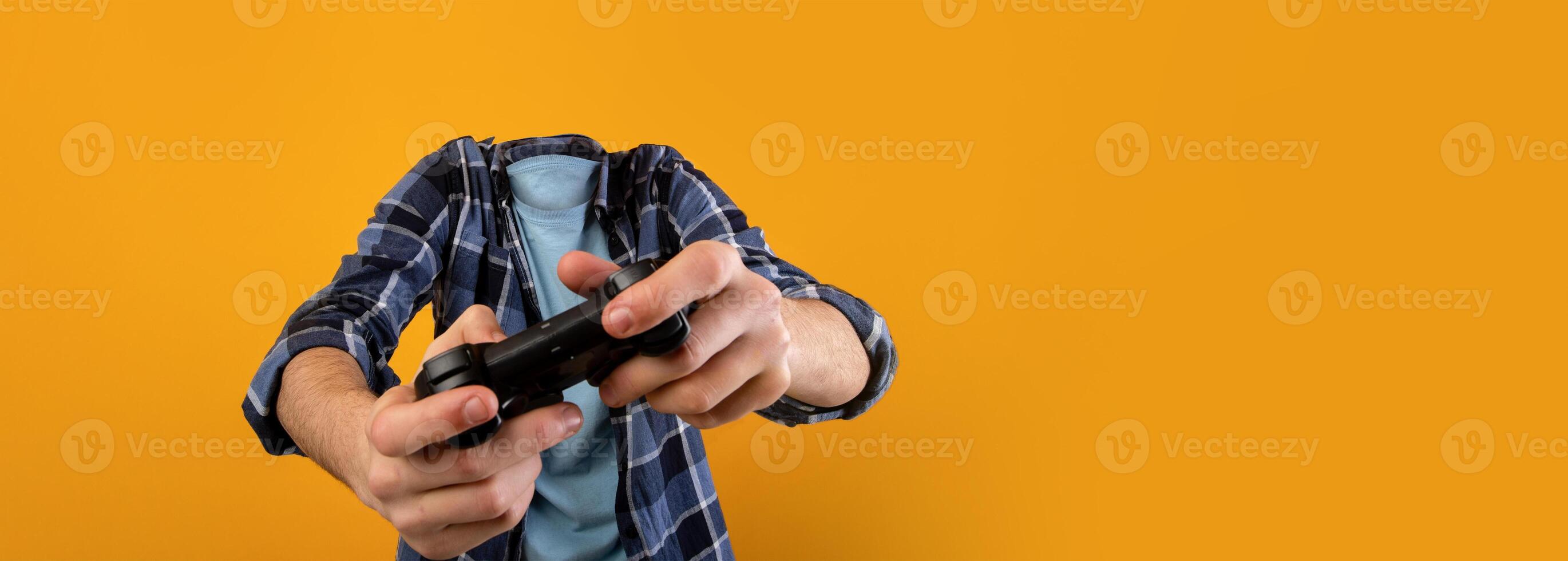 Two hands grip a game controller, lost in the virtual world, as a vibrant yellow backdrop enhances the mood of leisure and entertainment without showing any facial details. photo