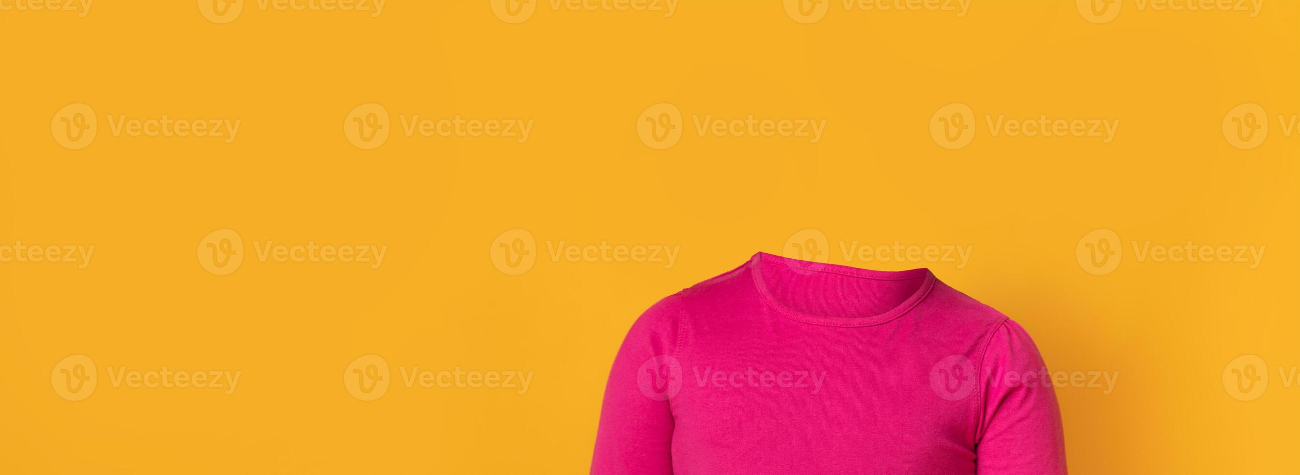 A headless figure in a vibrant pink shirt poses against a solid yellow backdrop. The unique presentation creates an isolated lifestyle collage with ample blank space. photo